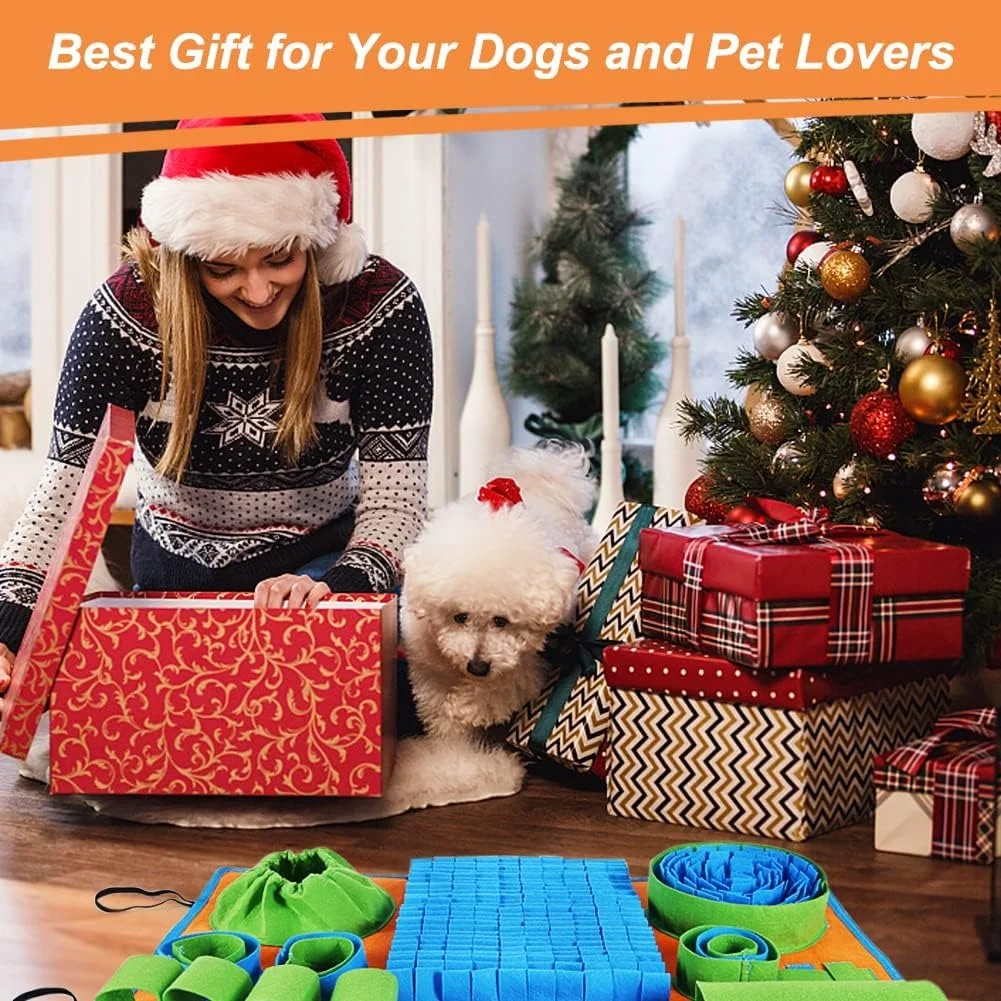 A woman opening a Christmas gift box with a white fluffy dog next to a dog snuffle and lick mat